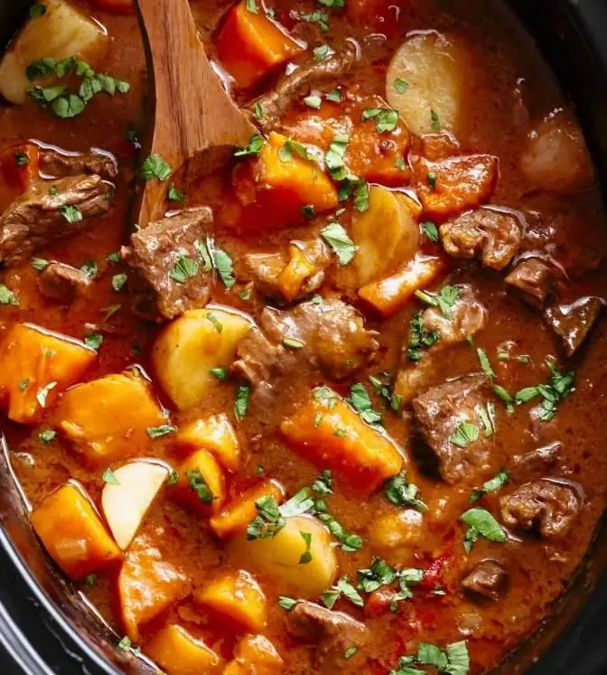 stewed beef with potatoes in a cauldron