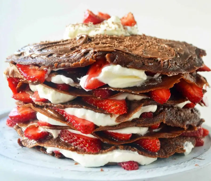 Chocolate pancake cake with whipped cream