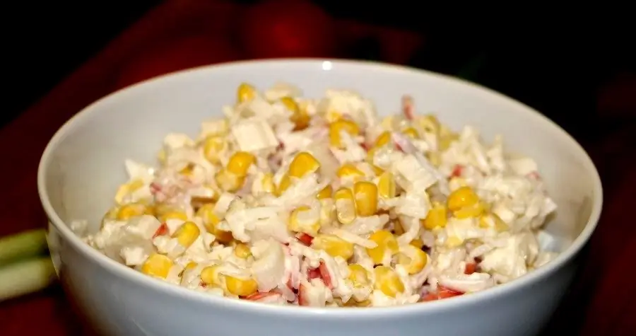 Various variations on a salad of crab sticks with corn and rice