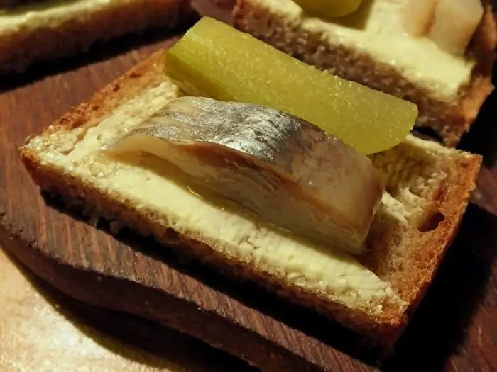 Festive canapes with herring for a buffet and banquet